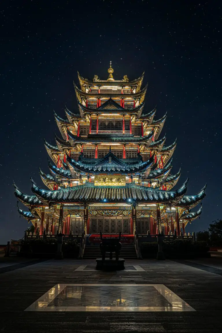 Stunning view of an illuminated pagoda temple in Chongqing at nighttime.